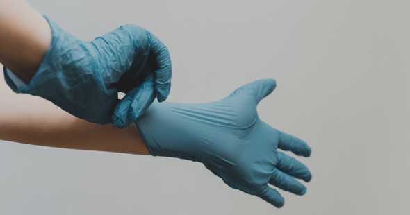 Putting on rubber gloves