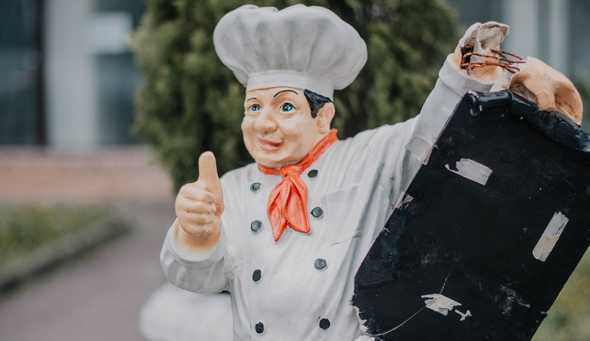 Slightly broken chef statue giving thumbs up